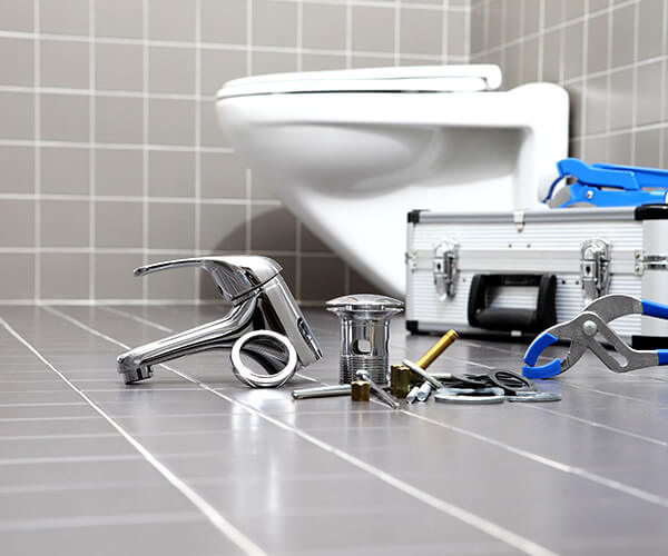 Plumbwell Services working on a residential bathroom service